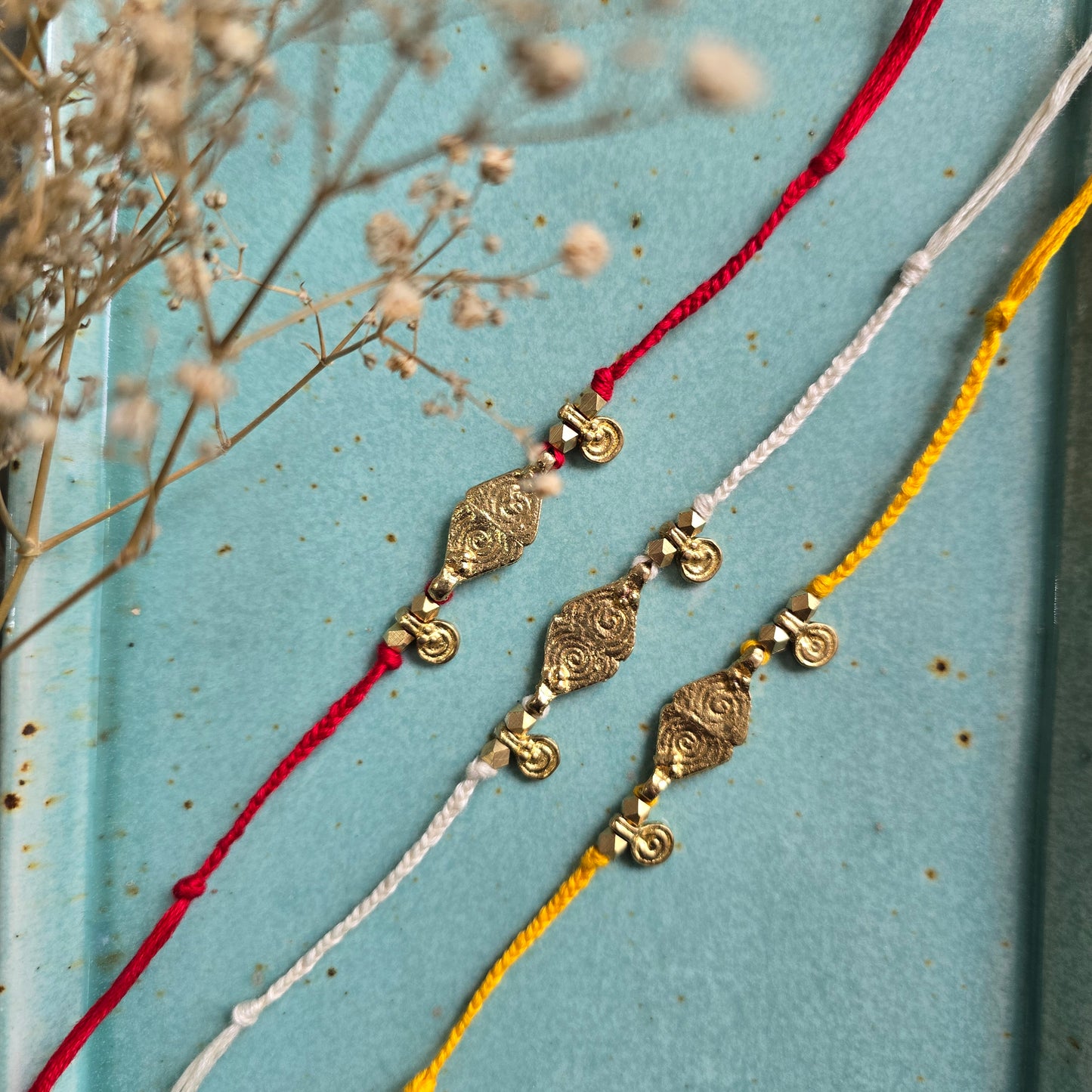 Brass Charms Rakhi - Set Of 3