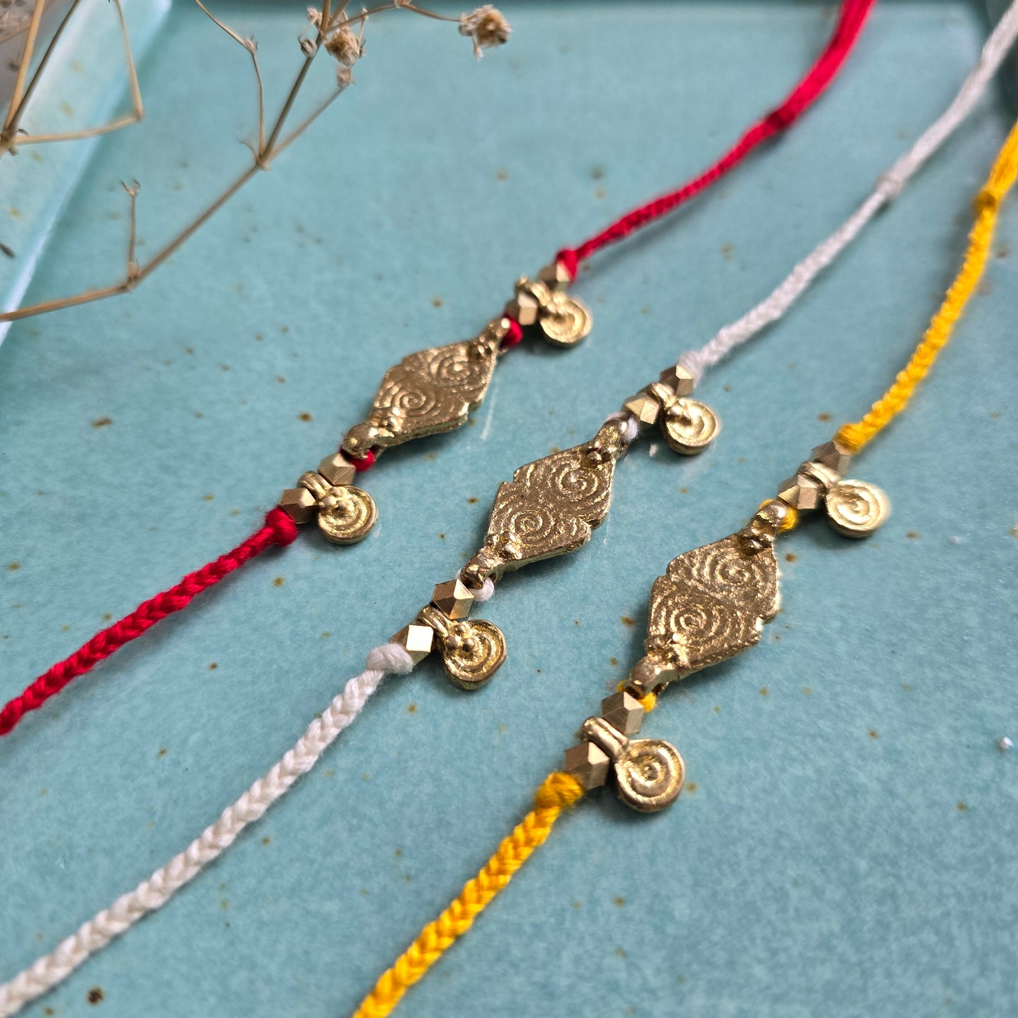 Brass Charms Rakhi - Set Of 3