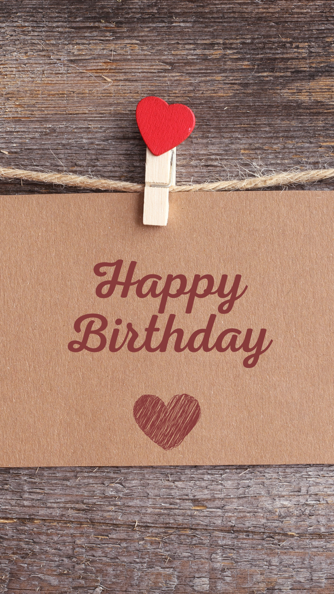 Happy Birthday card with a red heart and clothespin on a wooden background
