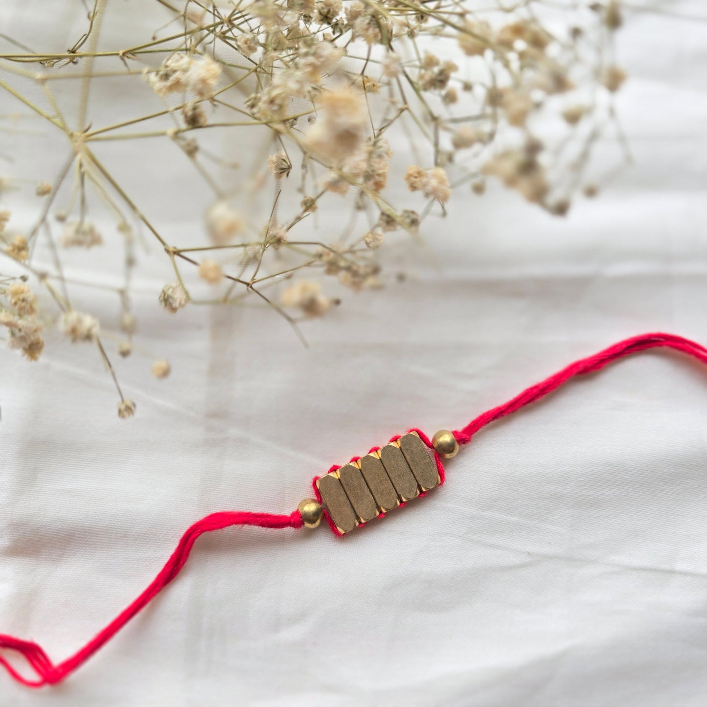 Rectangle Brass Beads Rakhi - english color