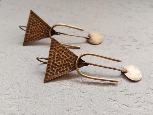 Triangular earrings with horse shoe and disc embellishments