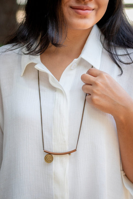 Crescent necklace with beaten disc and sphere ball