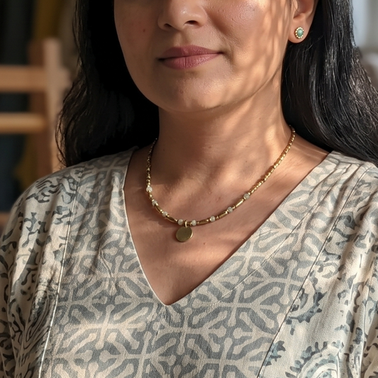 Woman standing in a workshop with weaving materials in the background