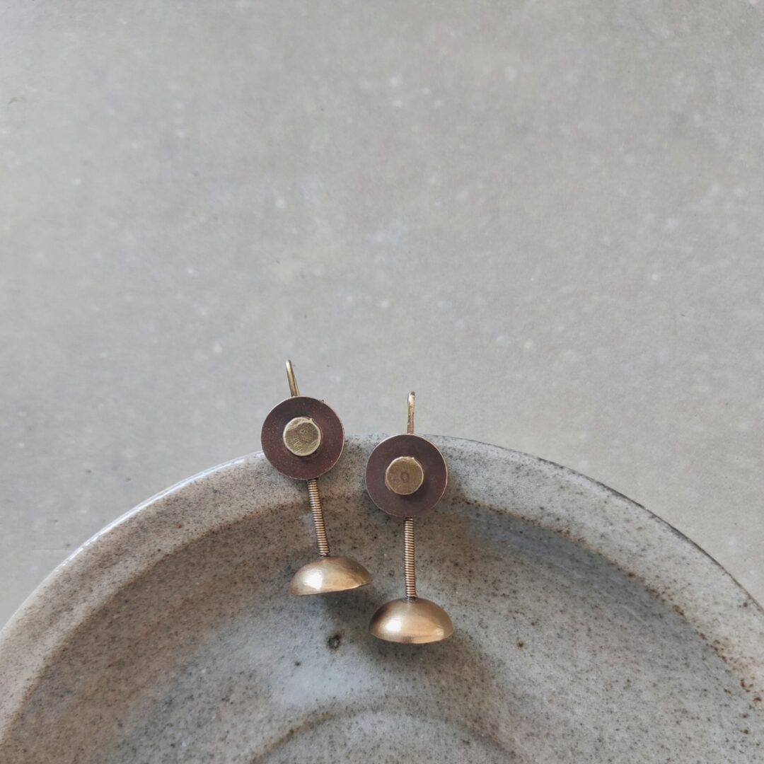 Mixed metal button with dome hooks