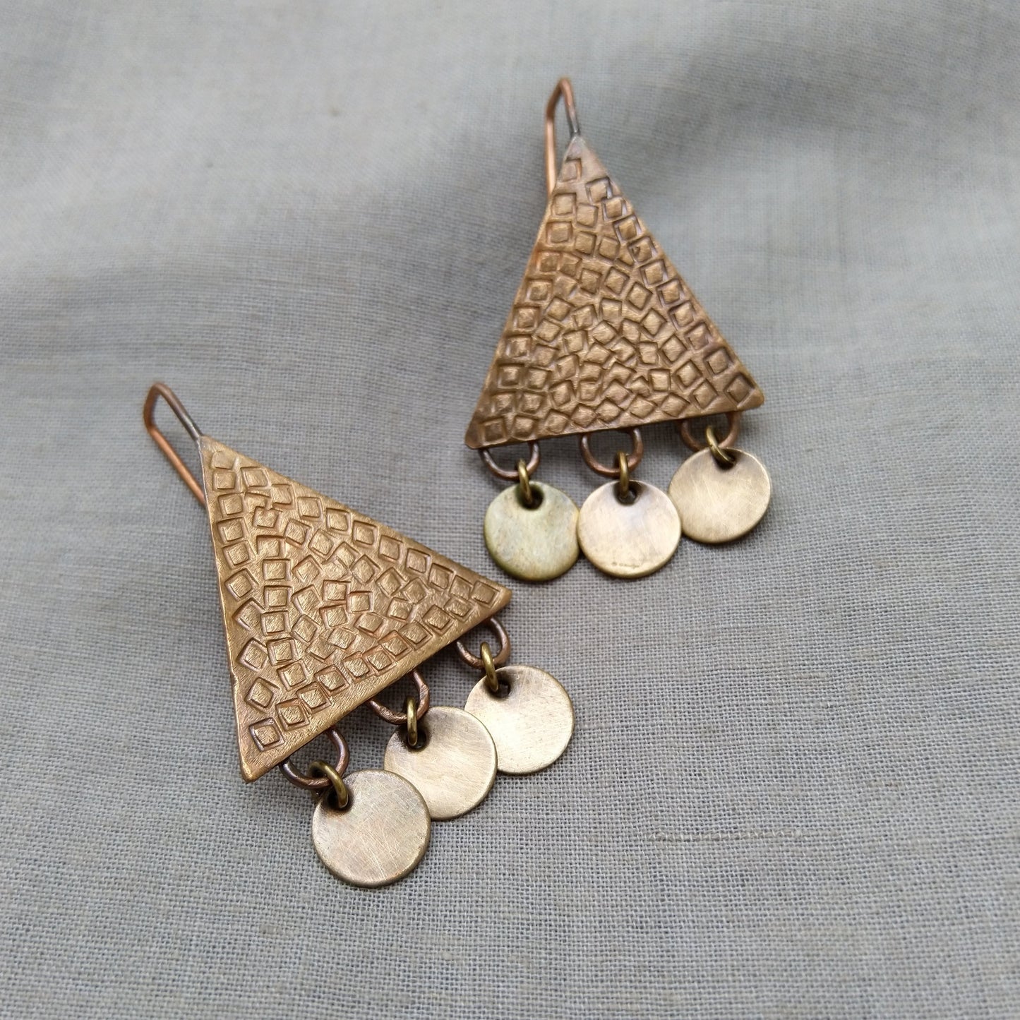 Triangular copper earrings with square texture