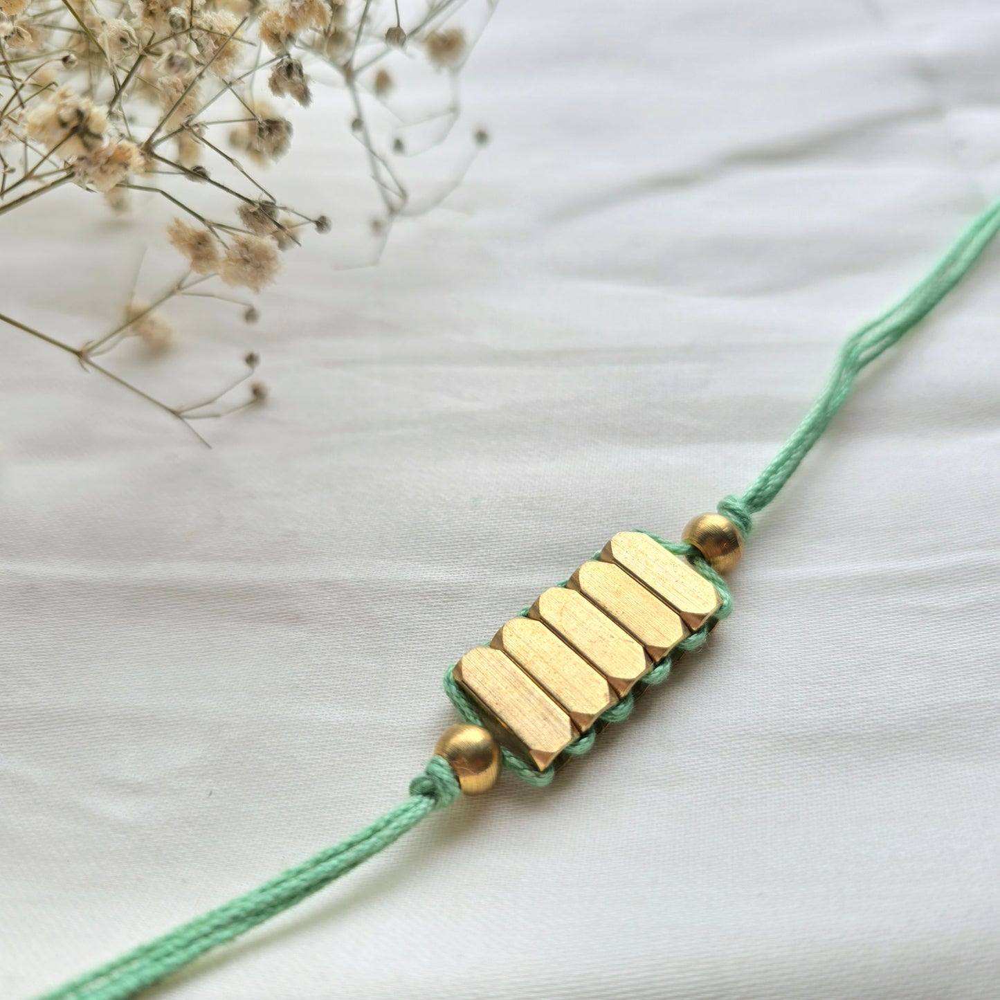Rectangle Brass Beads Rakhi - english color