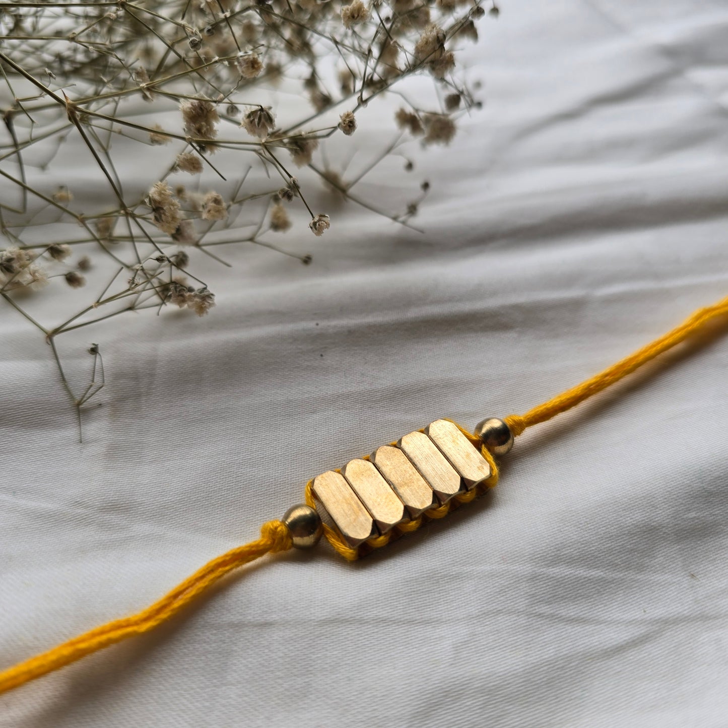 Rectangle Brass Beads Rakhi - english color