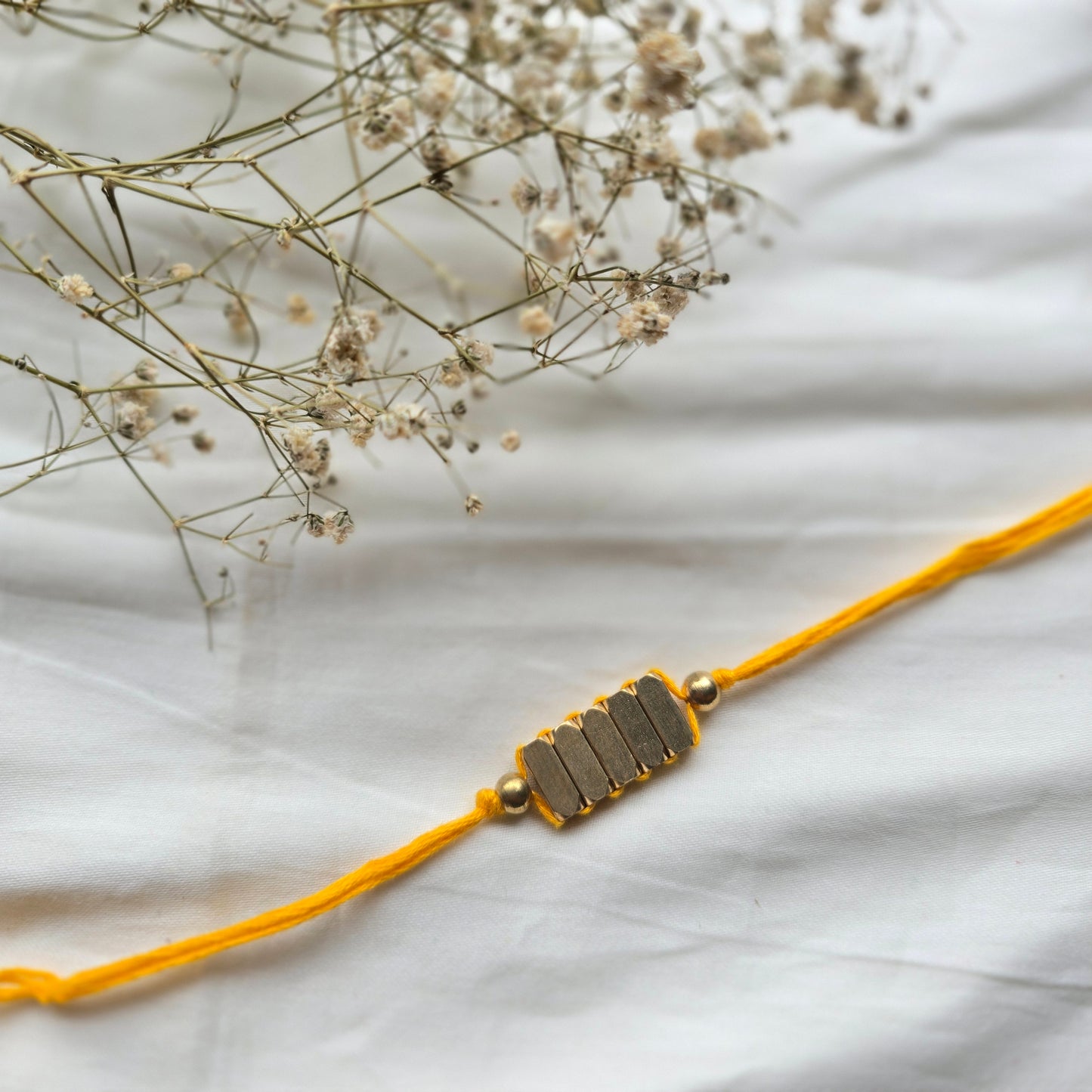 Rectangle Brass Beads Rakhi - english color