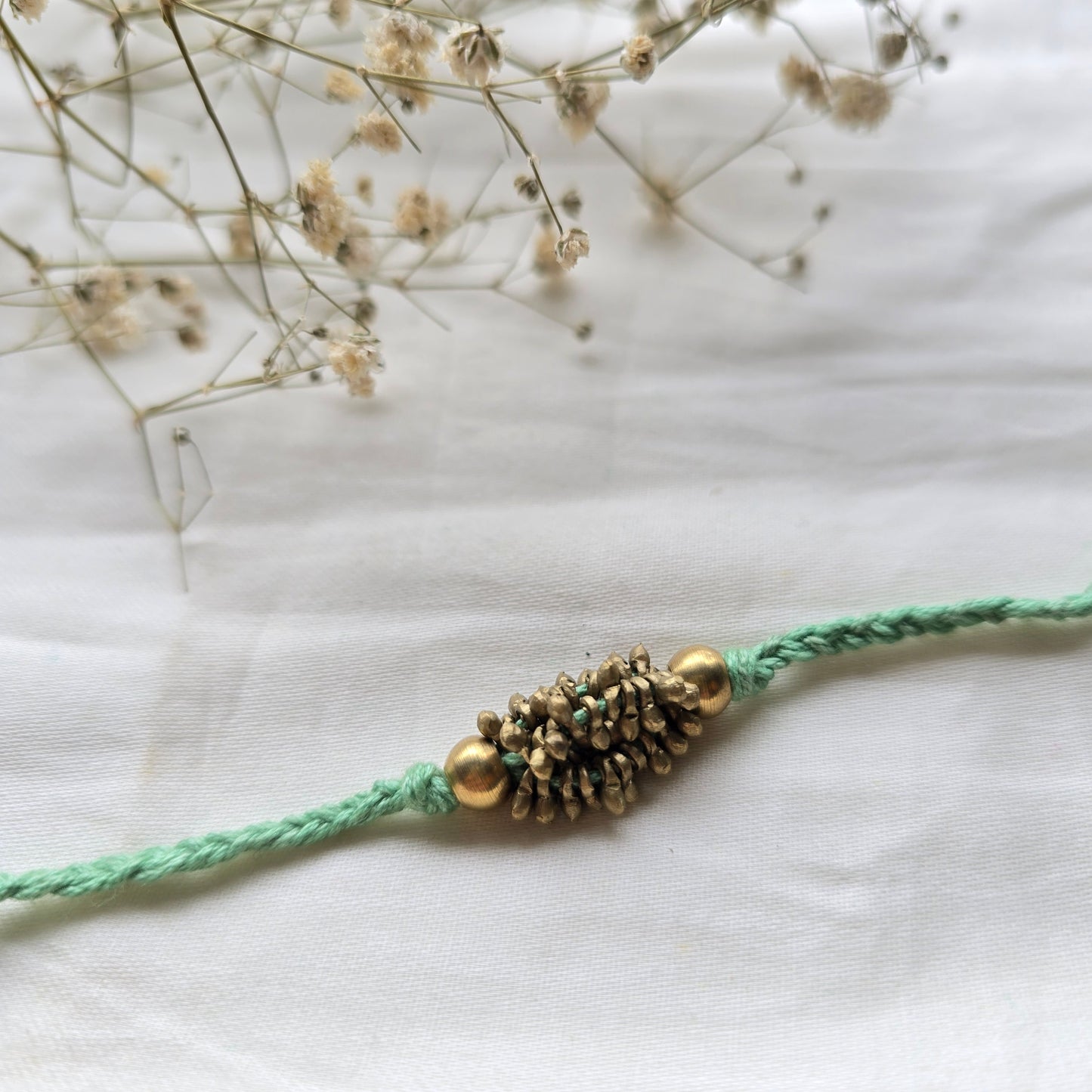Zarna Brass Beads Rakhi - English colors