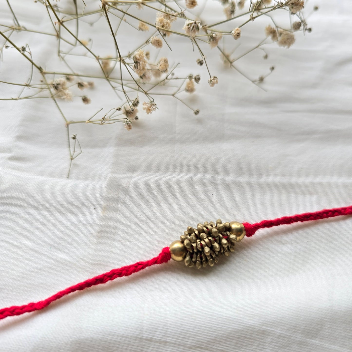 Zarna Brass Beads Rakhi - English colors